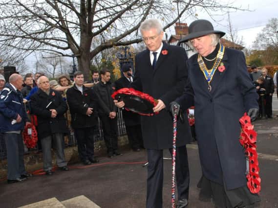 Andrew Jones MP and  County Councillor Margaret-Ann de Courcy Bayley prepare to lay their wreaths (1611133AM8).