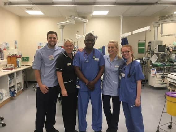 Resus nurse Jonathon Parker (left) with Dr Lenny Machache (middle) and staff from the A&E team
