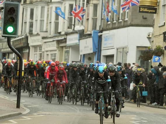 A team Sky rider at the head of the peleton making its way down Knaresborough High Street in the rain on Stage One of the Tour de Yorkshire.