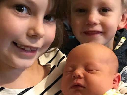 Baby Bertie snuggles up with his big sister Lola-Anne (6) and big brother Alfred (4). Picture: Rachel Sibley