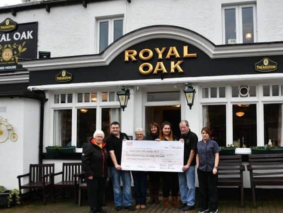 Staff at the Royal Oak in Nidderdale present the funds to Lin Stead, North Regional Fundraiser for the Yorkshire Air Ambulance