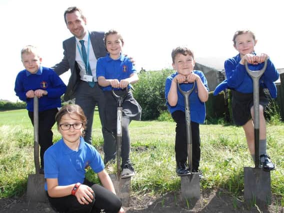 The headteacher of New Park Primary School, Robert Mold, with members of the school's gardening club. (1806054AM1)
