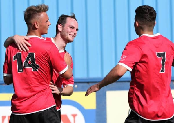 Brad Walker takes the congratulations of his team-mate after netting against Albion Sports. Picture: Craig Dinsdale