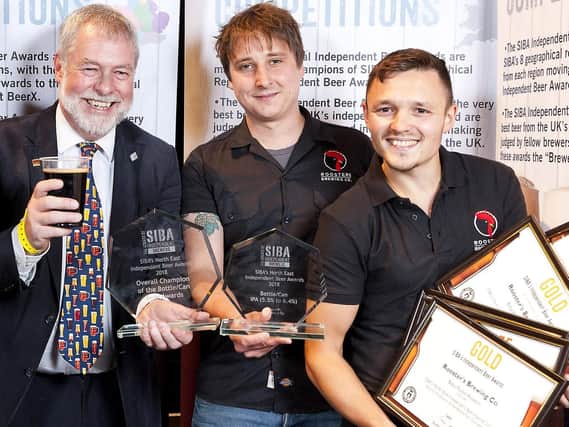 Oliver Fozard (centre) and Jamie McNamara collect Roosters five awards, presented by SIBAs Guy Shepherd.