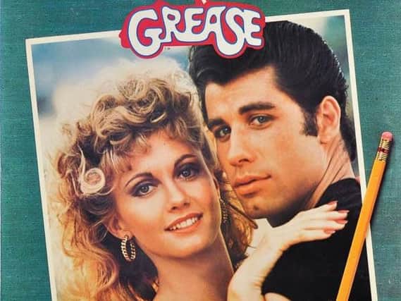 John Travolta and Olivia Newton John on the front cover of the soundtrack album of the classic film Grease.
