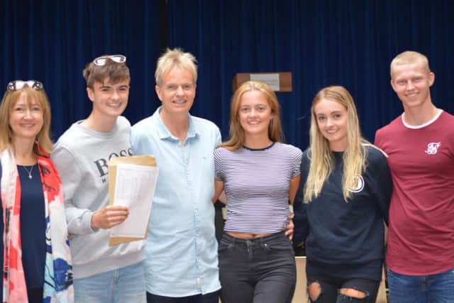 Students at St John Fisher's in Harrogate congratulate each other on GCSE success.
