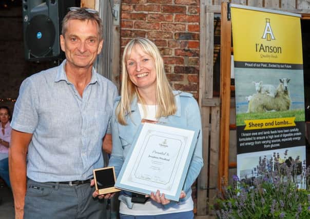 Jo Woollard receives her certificate of recognition and gold coin from managing director Chris IAnson. (S)