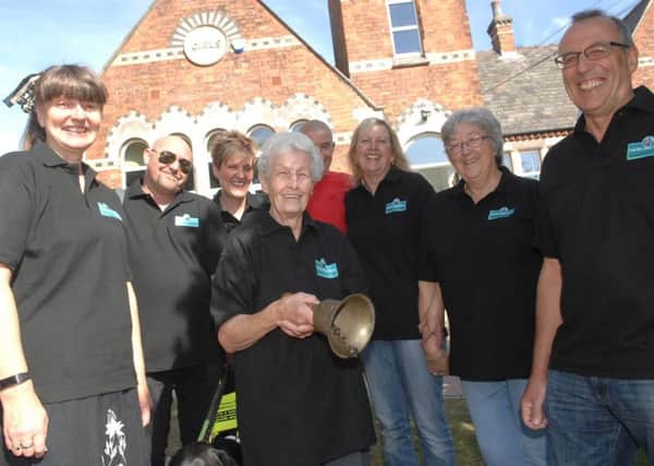 NAWN 1809011AM2 Old Girls School Sherburn.  Holding the old school bell Alma Hodgson with committee members Alyson Chambers, Gary Mercer, Melanie Heap, Tony Hewitt, Dawn Jaques, Sue Thornton and Andrew Potts. (180911AM2)