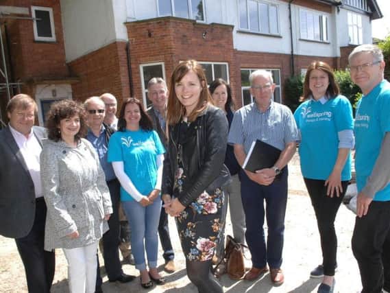 Excutive Director Emily Fullarton with volunteers, trustees and staff outside the soon to be opened home of Wellspring Therapy and Training. (1806053AM1)