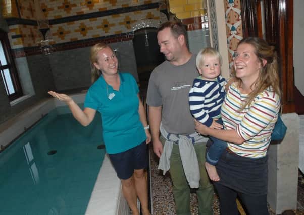 Hermann Rowinski with his wife Maxie and young son Barnaby are given a guided tour of the Turkish Baths by attendant Kasia Gryz. Tours will be held at the baths today (Thursday, September 13).