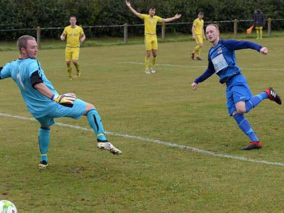 Charlie Yates fires past the Pool goalkeeper to hand Kirk Deighton Rangers a first-half lead during Saturdays encounter at Barr Field. Picture: Pete Arnett (KDRFC Media)