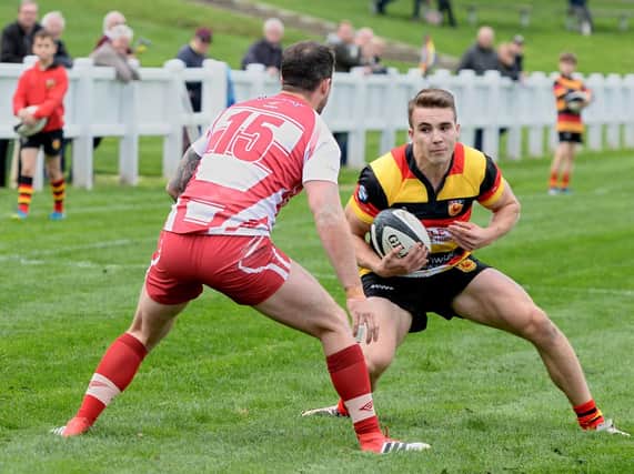 Harry Barnard looks for a way to the Wirral try-line. Picture: Richard Bown