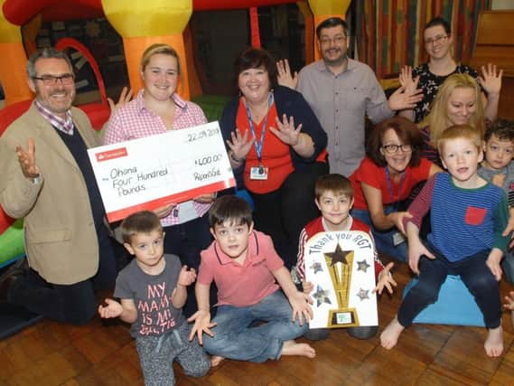 Organiser and judge of Ripon's Got Talent Lily Worth presents a cheque to the value of 400 to Elisa Wright, play leader at Ohana. Also in the picture is Ripon's Got Talent judge Andrew Roberts (RGT) Mike Riches, Chairman of Ohana play group, staff and youngsters (1809221AM1)