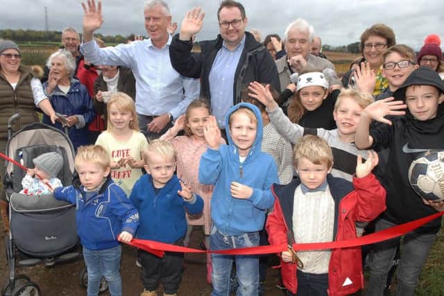 NAWN 1810131AM1 Walton Playground. Four years old Max Simpson cuts the ribbon to open the new playground watched on by friends and well wishers  including Brodie Clark (vice chair Walton Parish Council) and coun. Alan Lamb.  (1810131AM1)