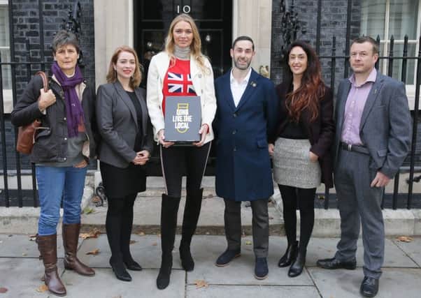 EDITORIAL USE ONLY

Publican Jodie Kidd delivers a petition, with publicans from across the UK, to 10 Downing Street calling for a cut in beer duty in the Autumn Budget, to help support local pubs. PRESS ASSOCIATION Photo. Picture date: Thursday October 18, 2018. The Long Live the Local petition, which is backed by Britains Beer Alliance, has gathered over 105,000 signatures and comes as data shows one in 10 pubs face risk of closure within the next five years. Photo credit should read: Tim Ireland/PA Wire