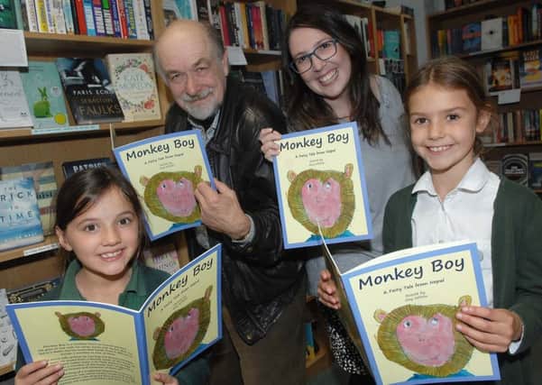 Ella Lambert, 8, and Charlotte Hale, 8, from Green Hammerton CofE Primary School with Rotarian Guy Wilson and Georgia Duffy, owner of Imagined Things, with copies of Monkey Boy.