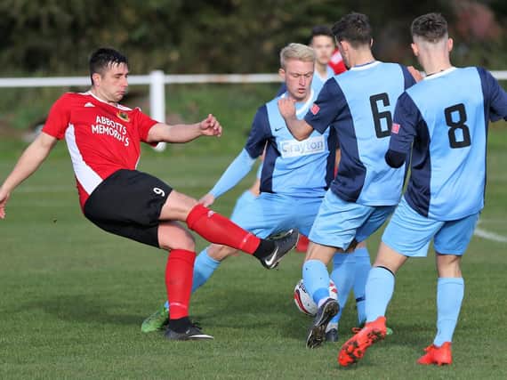 Knaresborough Town striker Paul Beesley's route to goal is blocked by a wall of Bottesford players. Picture: Craig Dinsdale