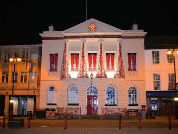 Ripon Town Hall's curtains of poppies illuminated at night. Picture: Rodney Towers.