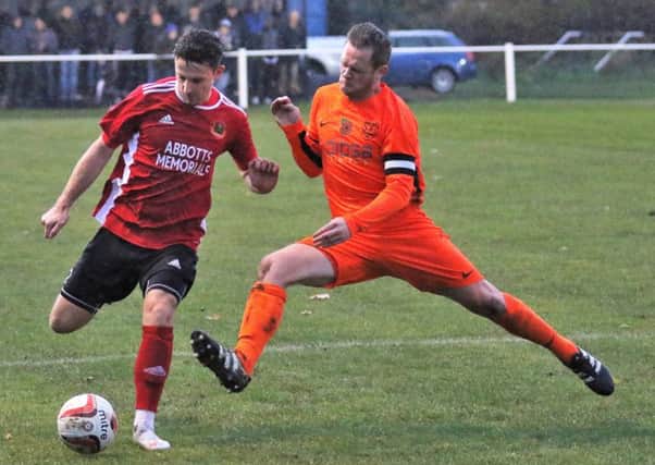 Knaresborough Town's Dan Thirkell is challenged by a Penistone man. Picture: Craig Dinsdale