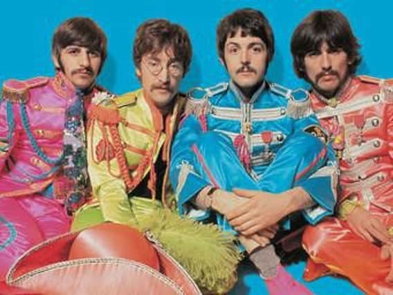 Posing for the inner cover of Sgt Pepper album - The Beatles.