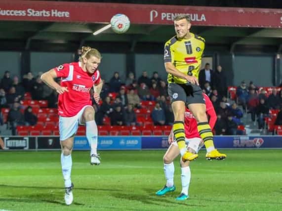 Jack Muldoon heads Harrogate Town into an early lead at Salford City. Picture: Matt Kirkham