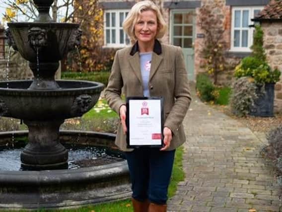 North Yorkshire success - Amy Stockdale, manager of The Old Coach House with the award from VisitEngland.