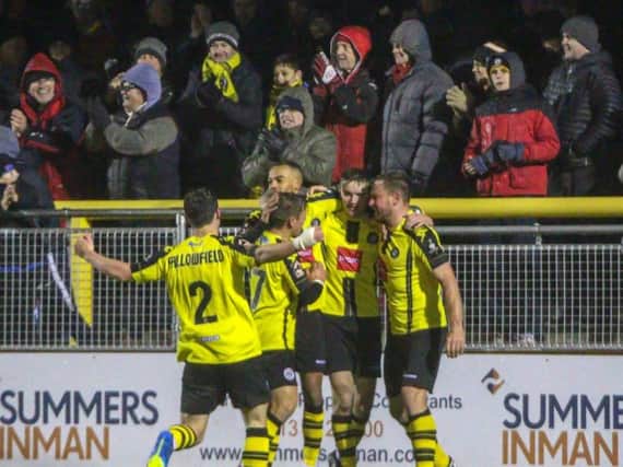 Harrogate Town players and supporters enjoy the club's FA Trophy win over York City. Picture: Matt Kirkham