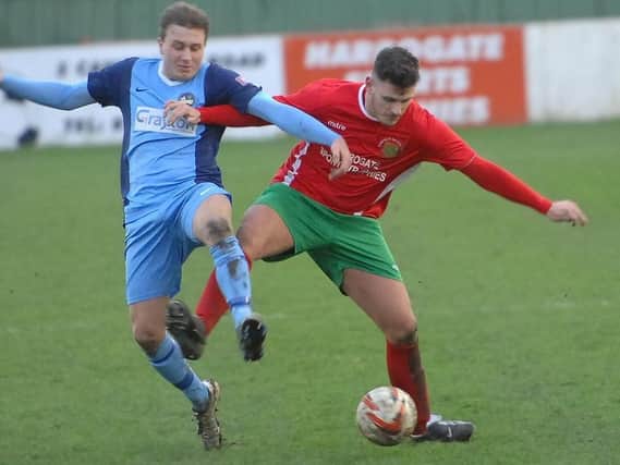 Harrogate Railway's Josh Underwood battles for possession during Saturday's draw with Bottesford. Picture: Adrian Murray