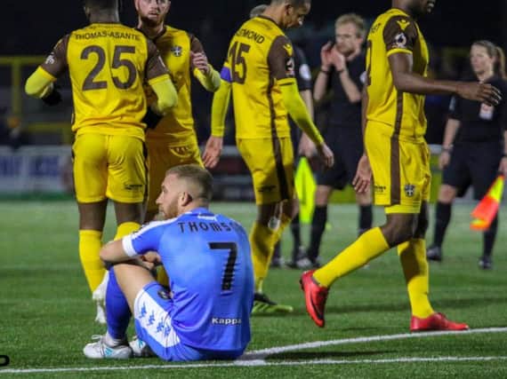 George Thomson cuts a dejected figure following Harrogate Town's fourth defeat in five matches, a 2-1 loss at Sutton United. Picture: Matt Kirkham