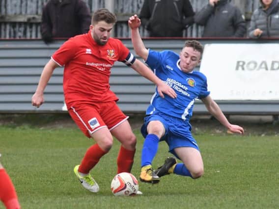 Harrogate Railway's Sam Barker challenges Bridlington Town skipper Andy Norfolk during Saturday's clash at Queensgate. Picture: Dom Taylor