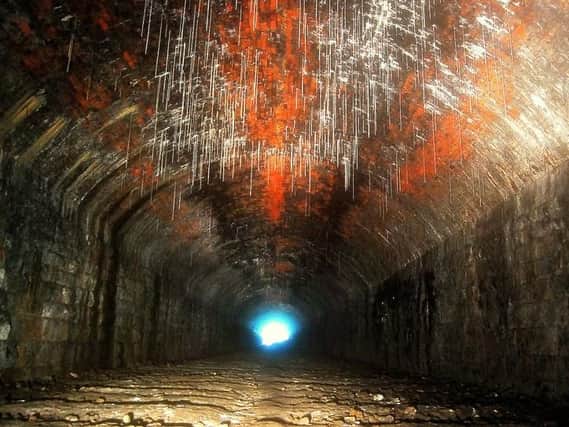 Stalactites and the indentations where the railway sleepers once lay can still be seen in the tunnel.
