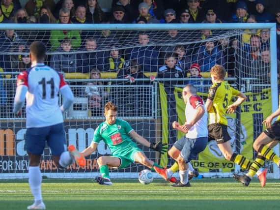 Harrogate Town goalkeeper James Belshaw is beaten by Frank Mulhern during Saturday's FA Trophy loss to Stockport County. Picture: Matt Kirkham