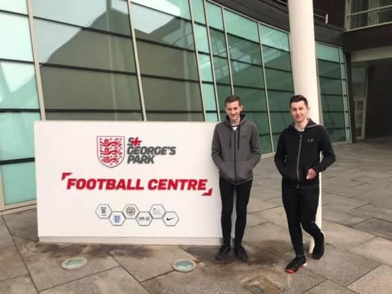 Cameron (right) with his brother Rhys at St Georges Park football centre.