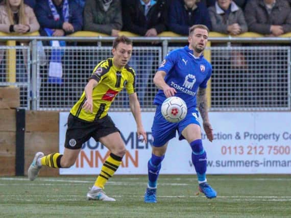 Jack Emmett and Lee Shaw compete for the ball during the 1-1 draw between Harrogate Town and Chesterfield at the CNG Stadium earlier this season. Picture: Matt Kirkham