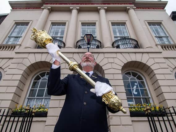 Jim Vauvert, Serjeant at Mace for Ripon City Council, holding the mayoral mace outside Ripon Town Hall.