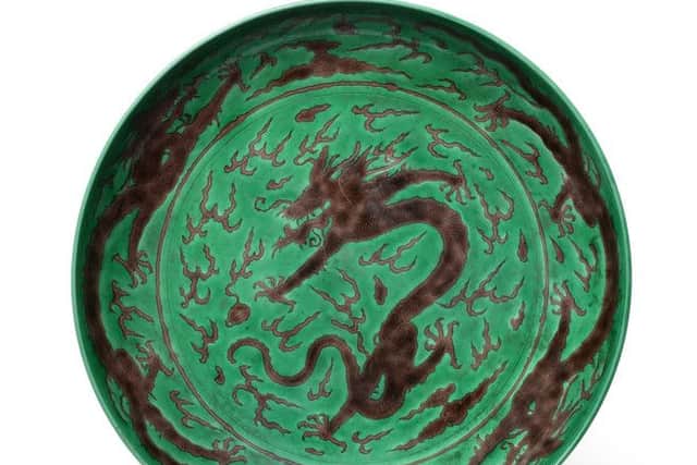 A Chinese Porcelain Green Ground Aubergine Dragon Dish, Kangxi reign mark and of the period, 32cm diameter  £10,000-15,000