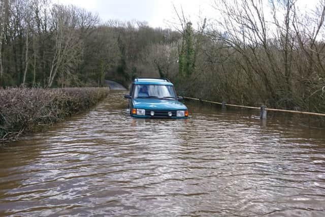 A car stuck in floods at Cock Beck in Stutton. (S)
