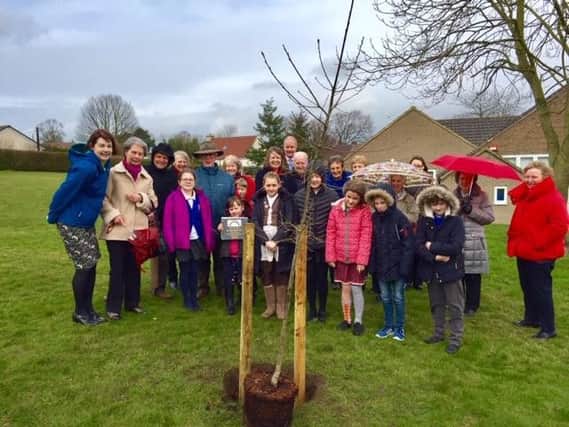Family, friends and teaching colleagues gathered at the school for the tree planting.