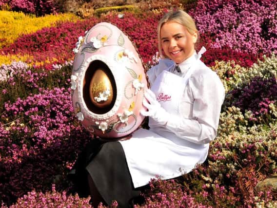 Bettys waitress Lauren Whittaker with the giant Centenary Imperial Easter Egg which costs nearly 500!