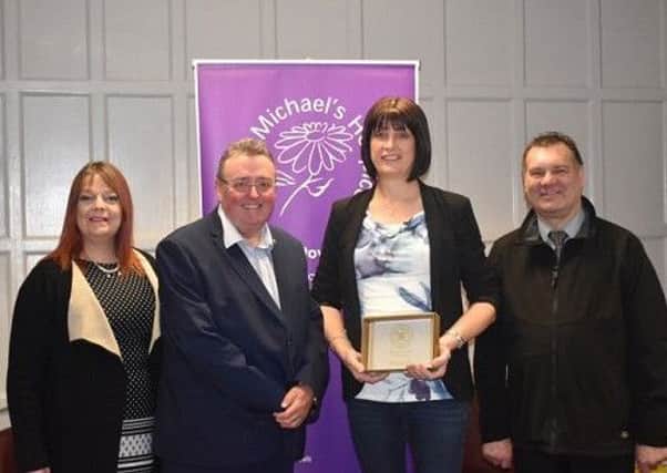 Amanda Ryder, owner of MJ Ryder, receives the Guild of Patrons plaque from Saint Michaels chief executive Tony Collins.