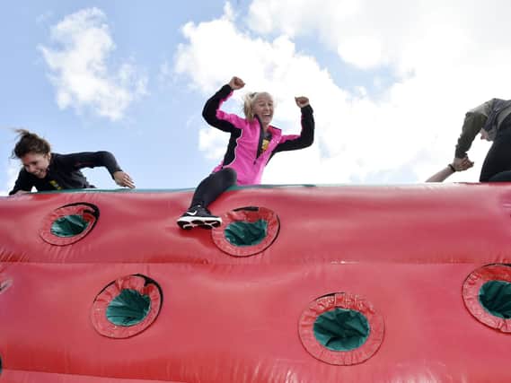 Amanda Lupton of Kippax reaches the top of one of the inflatables