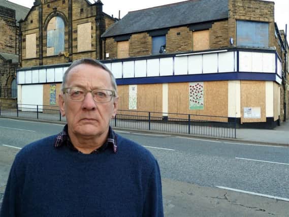 Eyesore - Harrogate Borough Council Coun Philip Broadbank with the ex-McColls site behind him in Starbeck in Harrogate.