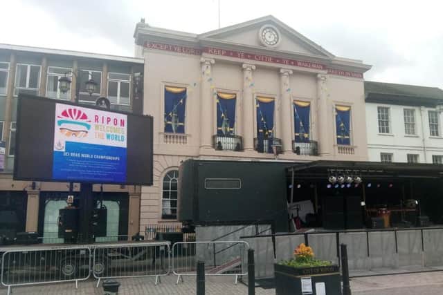 The big screen in the Square for the Tour, with the Town Hall's commemorative drapes in the background.