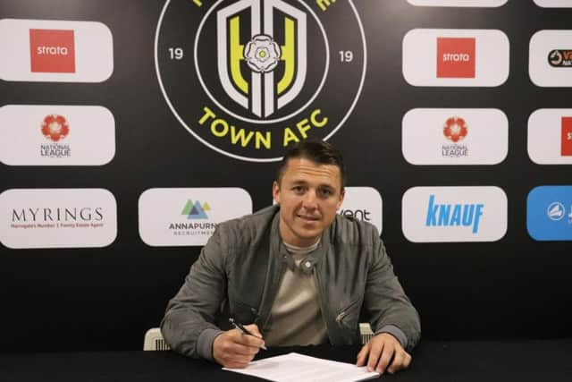 Scott Brown puts pen to paper on his deal with Harrogate Town. Picture: Matt Kirkham