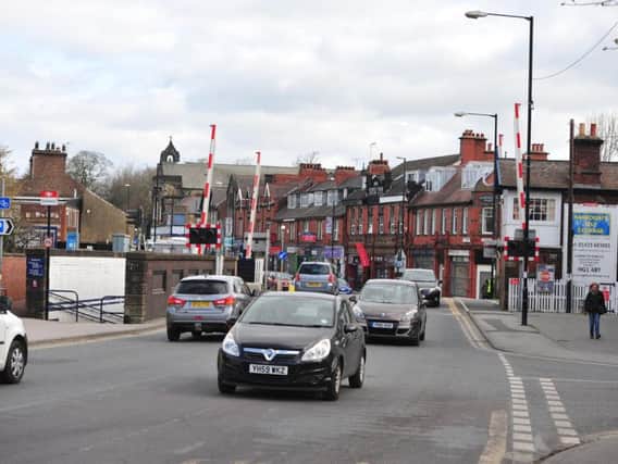 Heavy traffic, static queues and exhaust fumes - The busy railway crossing at Starbeck High Street in Harrogate.