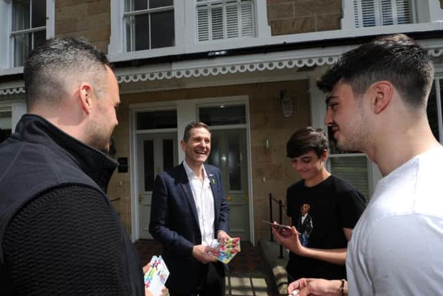 Officials from organisers Yorkshire 2019 in Harrogate handing out leaflets about the UCI cycling championships - Nick Howles and Andy Hindley chat to Swan Road residents Daniel and Ben Raubitschek. (Picture: Gerard Binks)