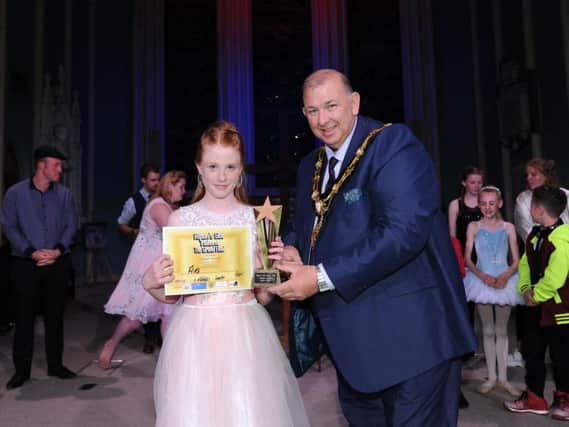 Ava Harper is presented with the judges' prize by the Mayor of Ripon, Coun Eamon Parkin.