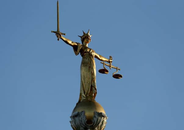 FW Pomeroy's Statue of Justice stands atop the Central Criminal Court building, Old Bailey, London.