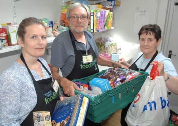 NAWN 1807241AM1 Wetherby Food Bank. Project manager Claire Fleetwood with  team leader John Borman and volunteer Sheila Hollaway.   (1807241AM1)