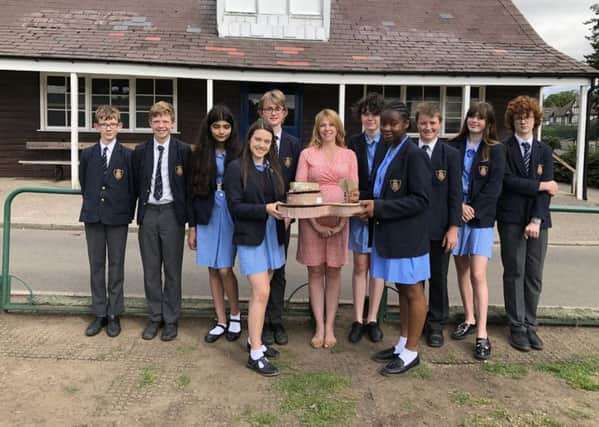 Ripon Grammar School students with the design of the modern cricket pavilion, with the ancient beech tree taking pride of place.